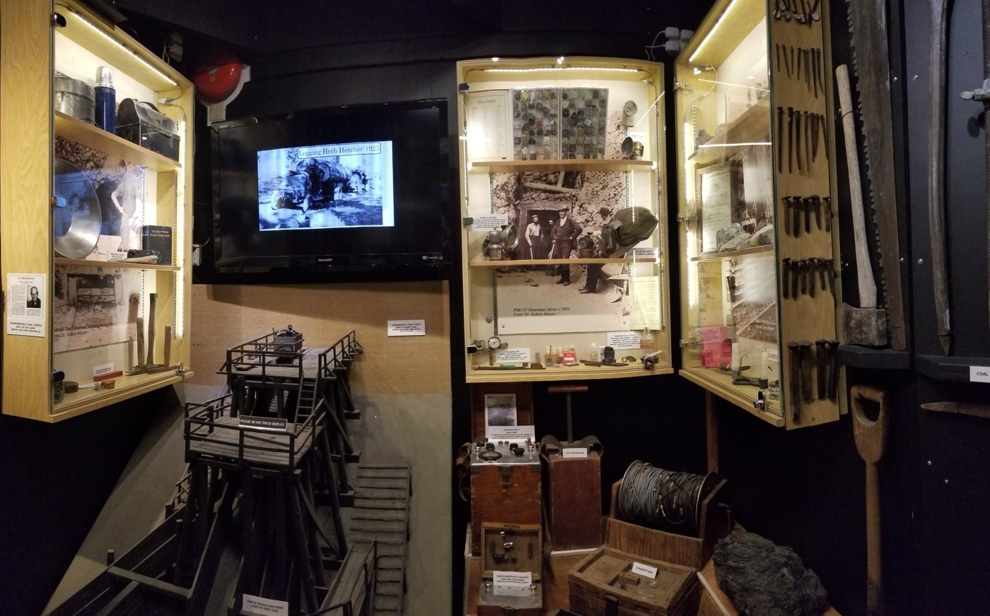 Mining display with tools, models and photographs